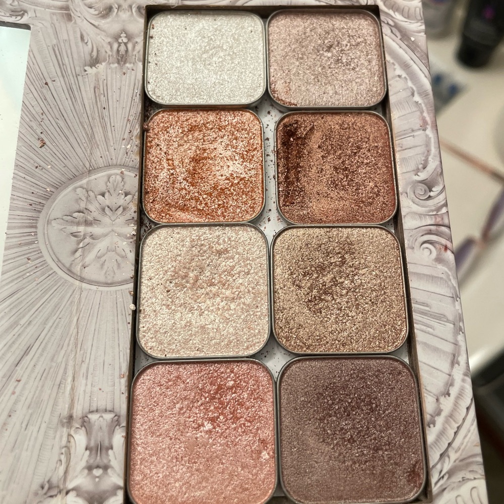 14 Barely used Seint eye shadows. Various assorted colors.